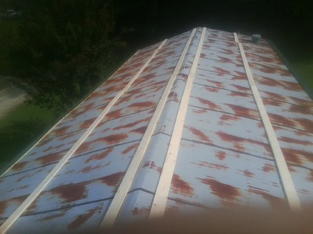 Rusted metal roof panels with new wood purlins before replacement — Storm Damage Roof Repair in Waitsburg by Roofing Brothers